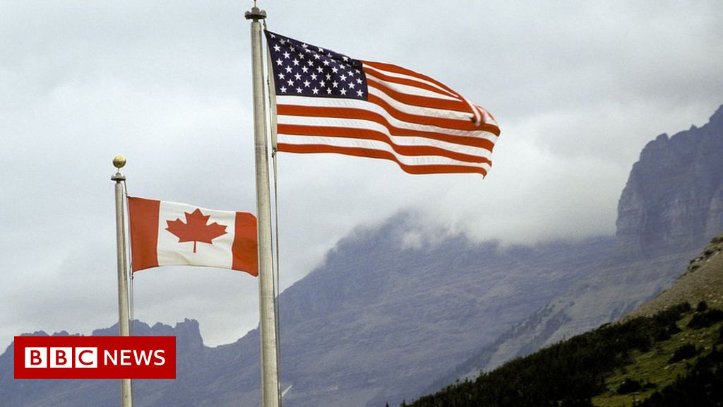 American and Canadian flag flying together