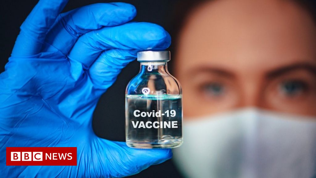Woman holding vaccine vial
